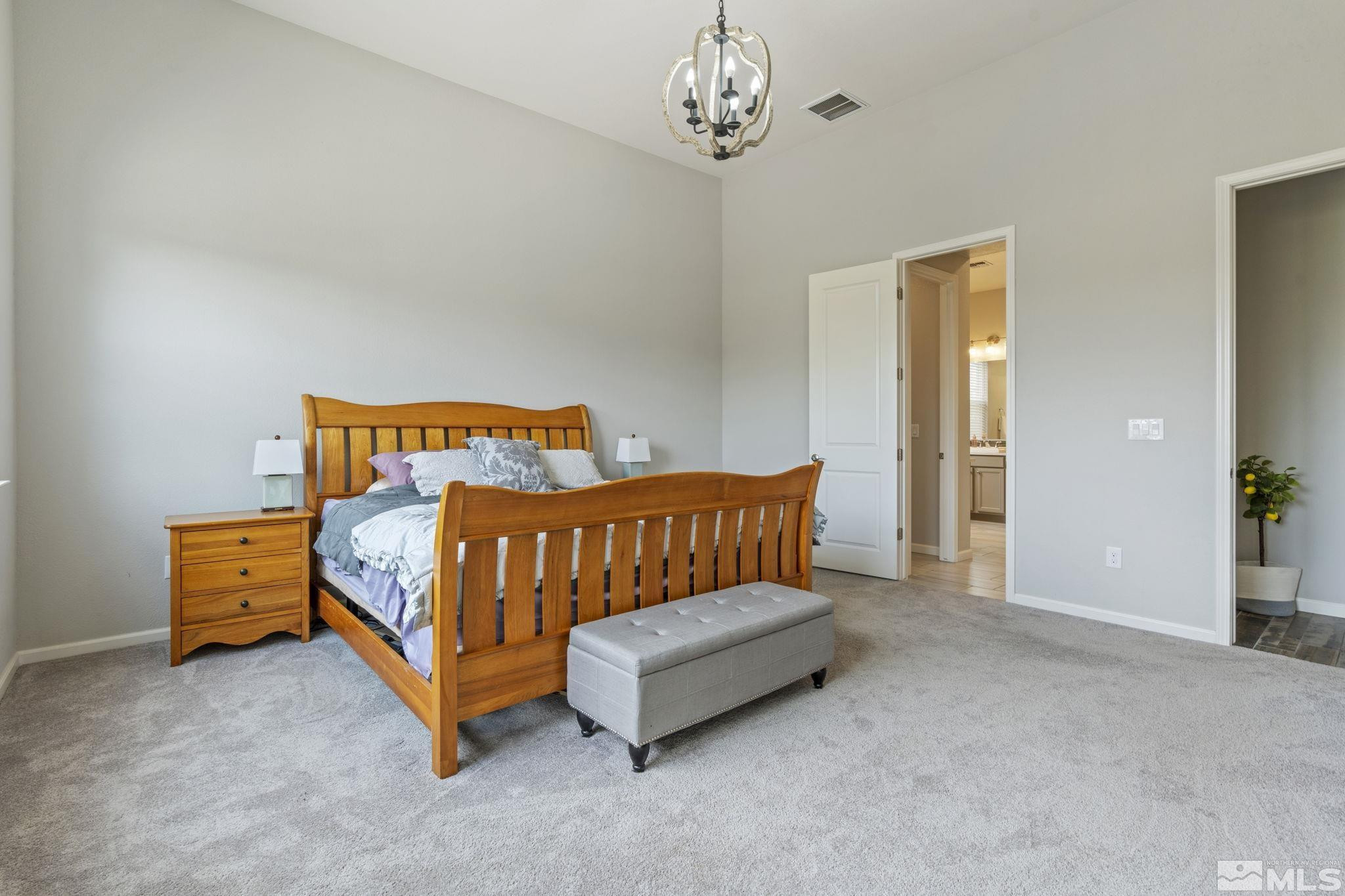 2305 Buttermere Drive Reno, NV 89521 - Photo 17 of 39 a bedroom with a bed and a chandelier