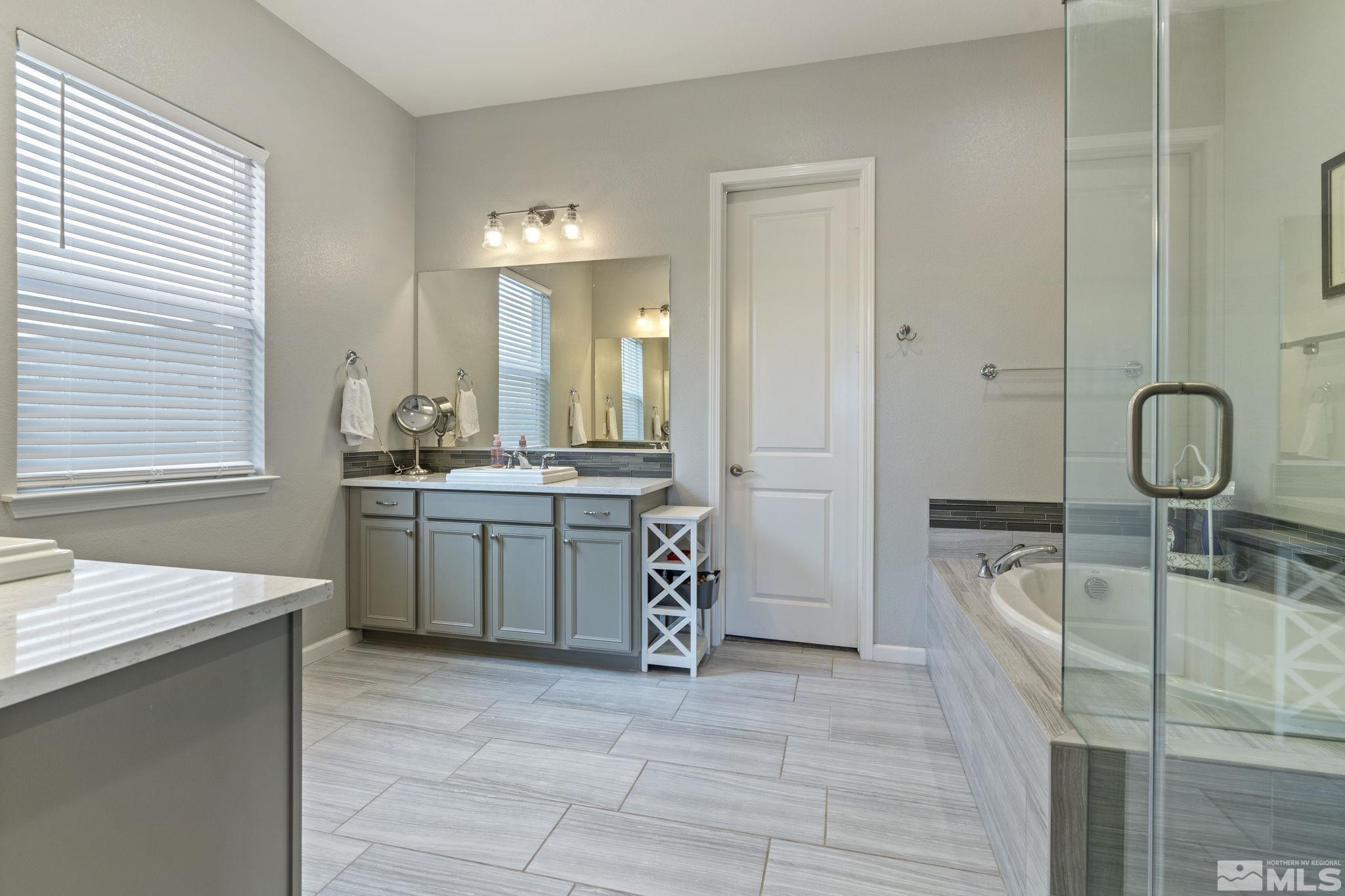 2305 Buttermere Drive Reno, NV 89521 - Photo 18 of 39 a spacious bathroom with a double vanity sink a mirror and a bathtub