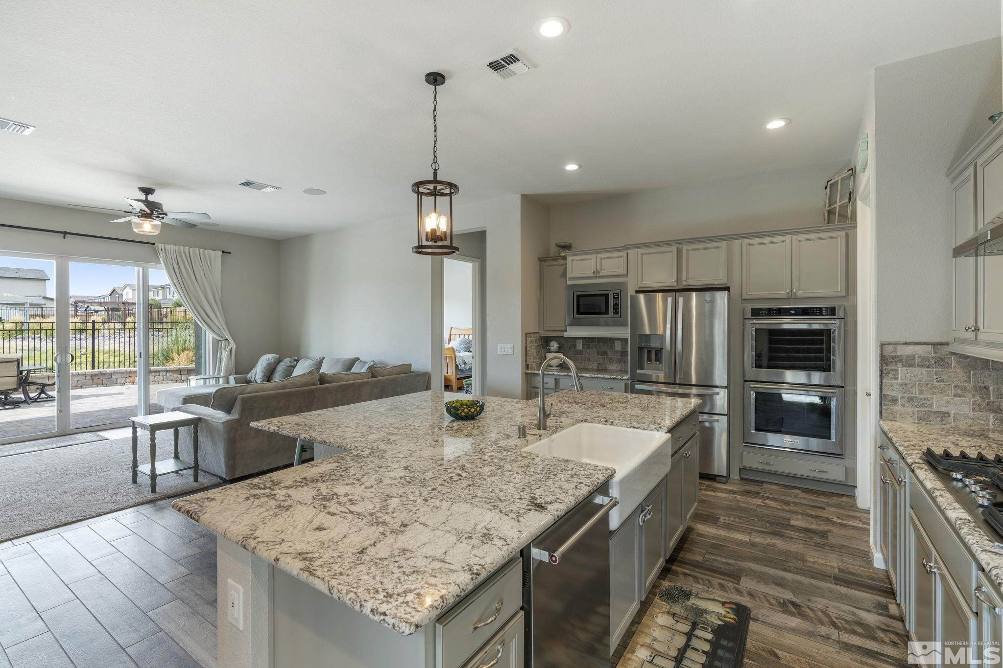 2305 Buttermere Drive Reno, NV 89521 - Photo 3 of 39 a kitchen with stainless steel appliances granite countertop a sink and a refrigerator