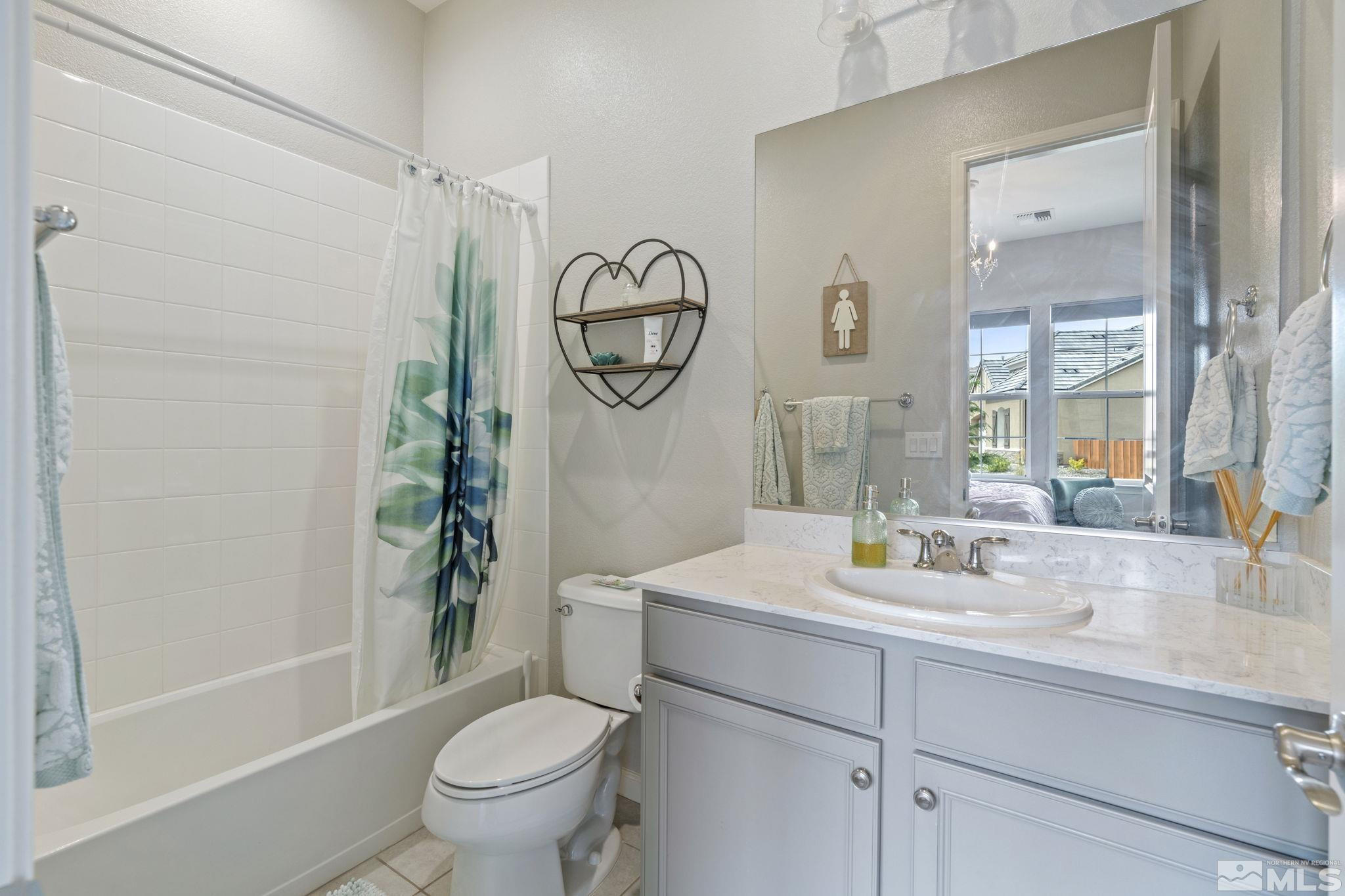 2305 Buttermere Drive Reno, NV 89521 - Photo 33 of 39 a bathroom with a toilet a sink and a mirror