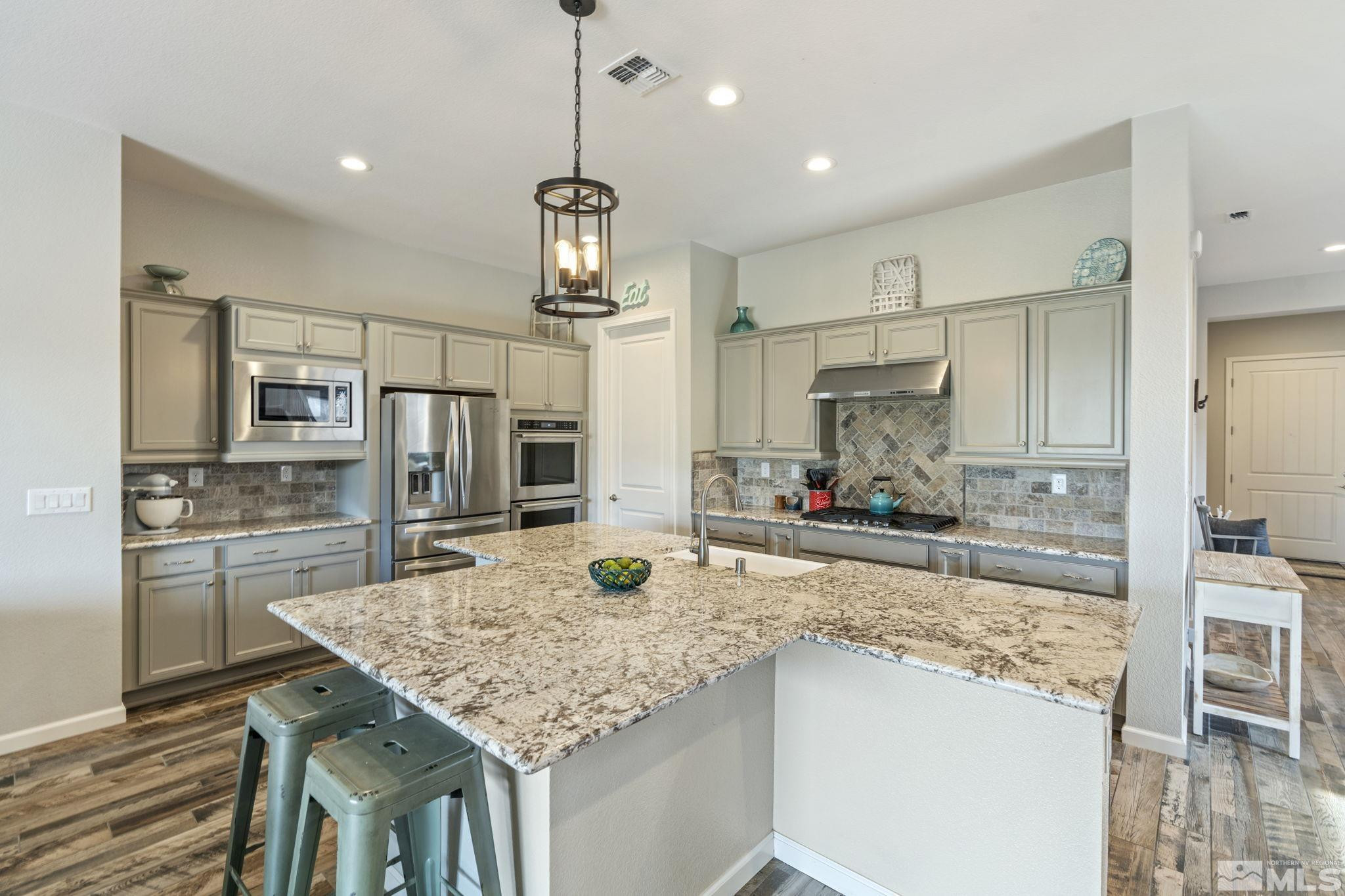 2305 Buttermere Drive Reno, NV 89521 - Photo 5 of 39 a kitchen with kitchen island a counter top space appliances and cabinets