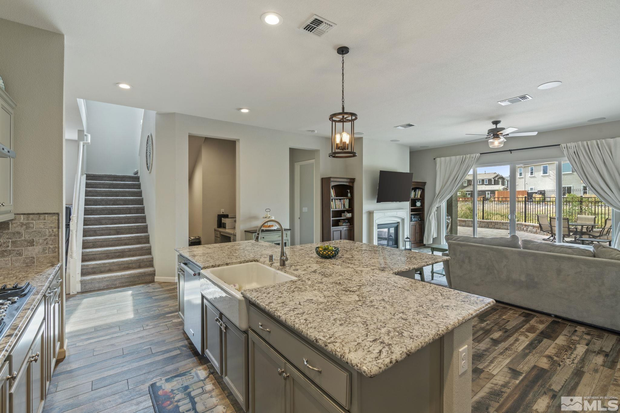 2305 Buttermere Drive Reno, NV 89521 - Photo 7 of 39 a large kitchen with kitchen island a sink stove and wooden floor