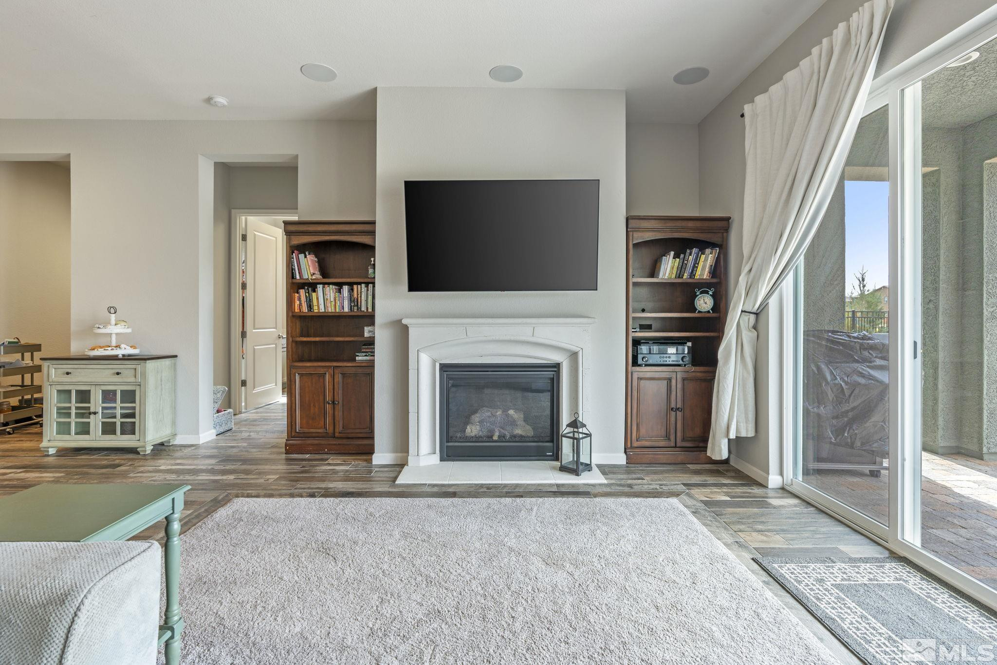 2305 Buttermere Drive Reno, NV 89521 - Photo 10 of 39 a living room with furniture a flat screen tv and a fireplace
