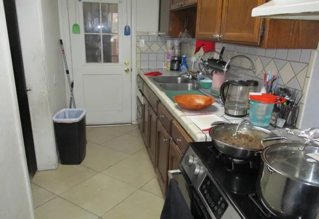 a kitchen with stainless steel appliances a sink stove and cabinets