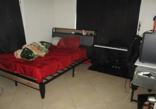 a bed sitting in a bedroom next to a window