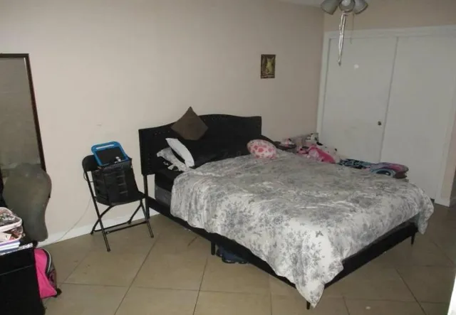 a bed sitting in a bedroom next to a window