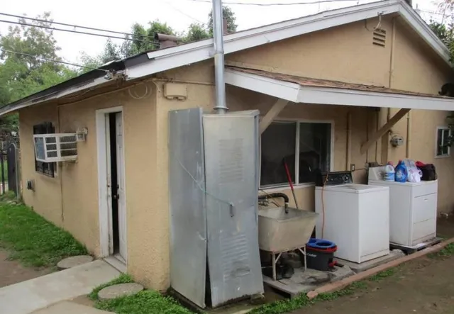 a view of a patio with table and chairs and potted plants
