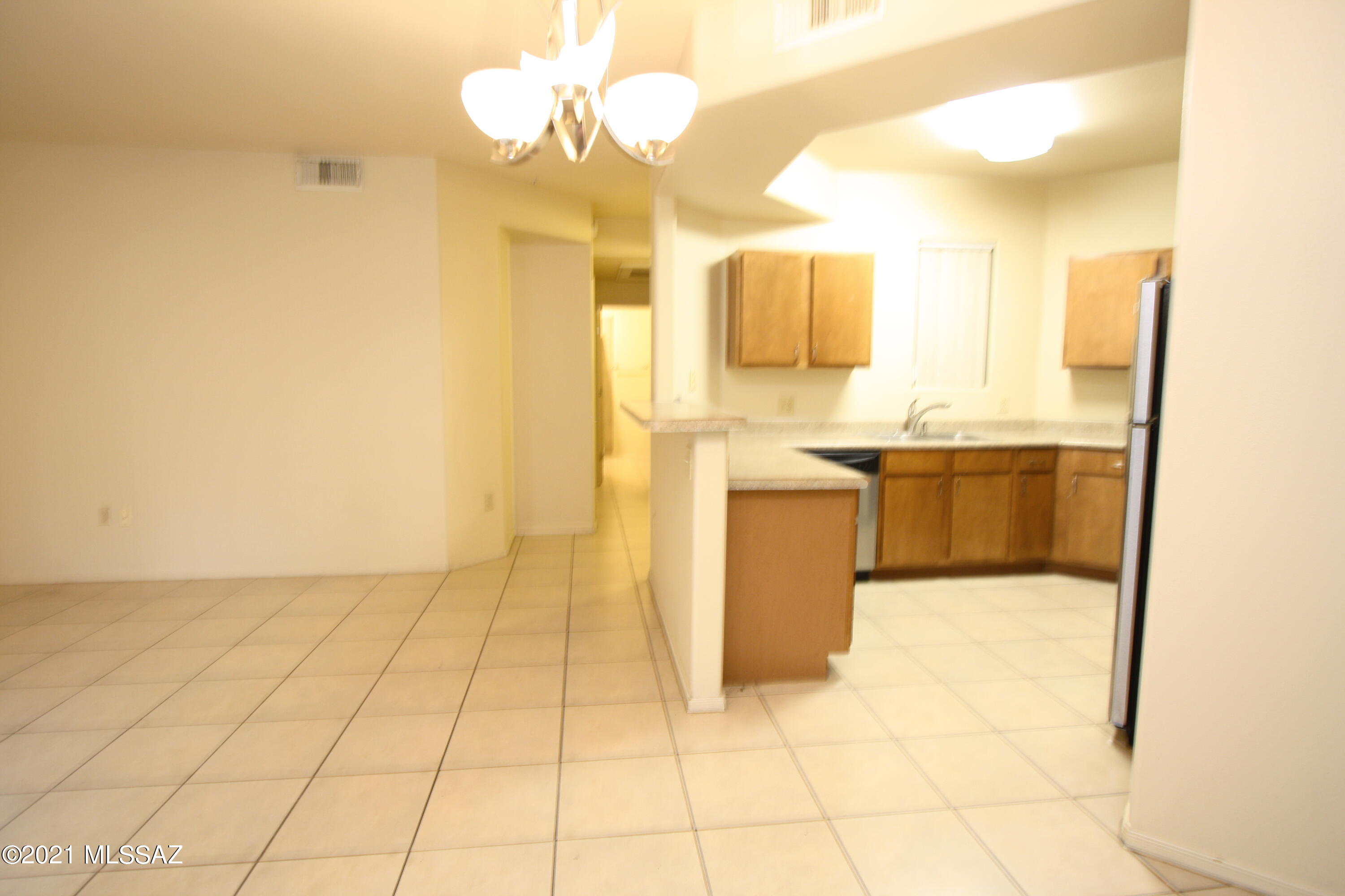 2550 East River Road, Unit 5104 Tucson, AZ 85718 - Photo 6 of 14 a kitchen with stainless steel appliances a sink and cabinets