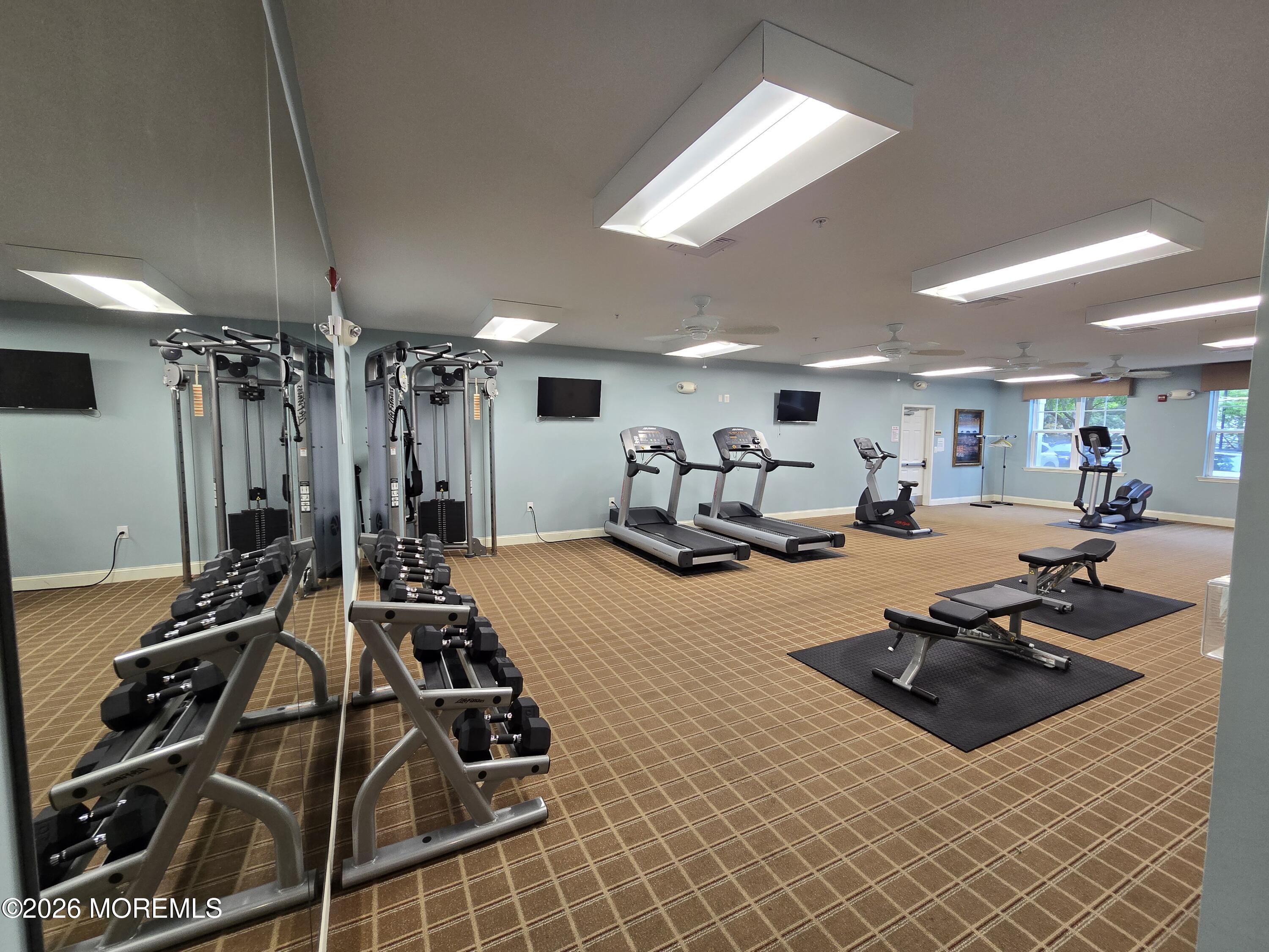 2201 River Road, Unit 4207 Point Pleasant, NJ 08742 - Photo 31 of 34 a room with gym equipment and a large window