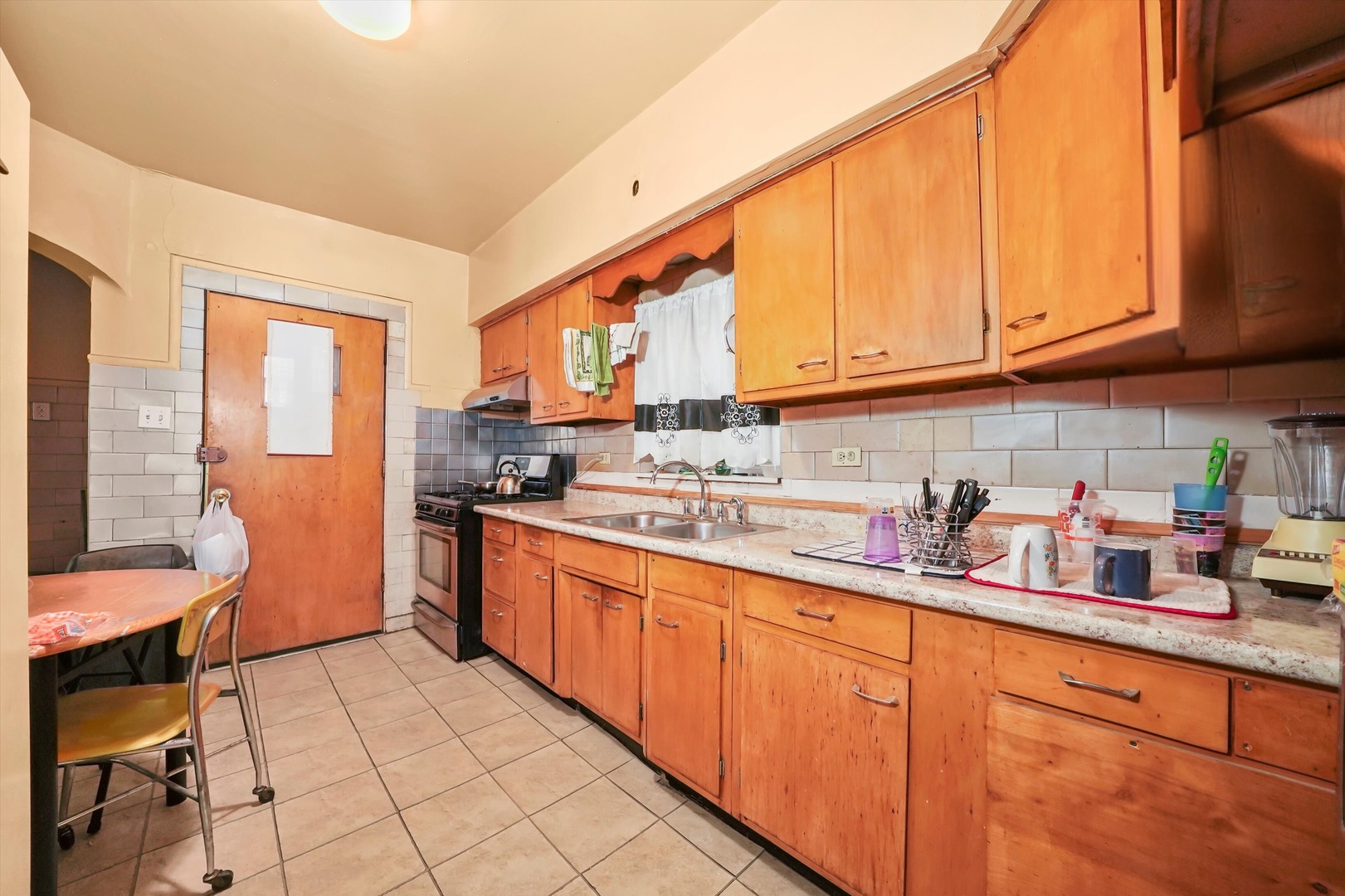 7825 South Phillips Avenue Chicago, IL 60649 - Photo 11 of 55 a kitchen with stainless steel appliances granite countertop a sink and cabinets
