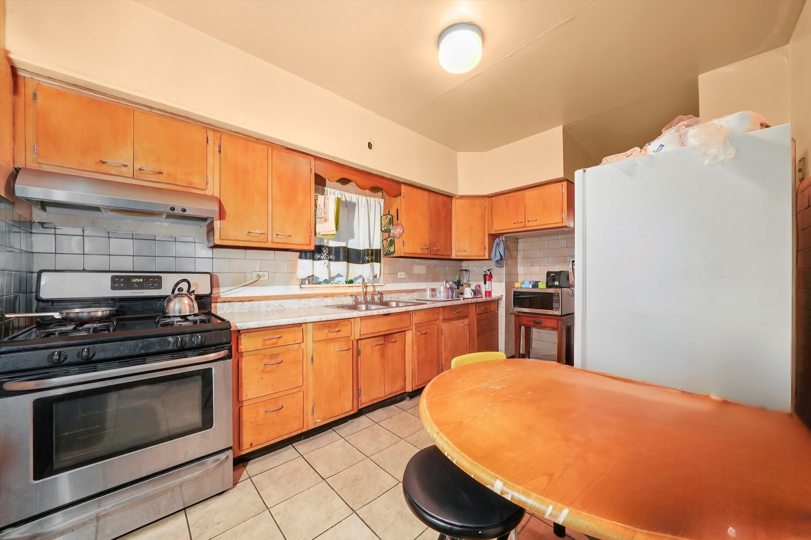 7825 South Phillips Avenue Chicago, IL 60649 - Photo 12 of 55 a kitchen with stainless steel appliances a stove a sink and cabinets
