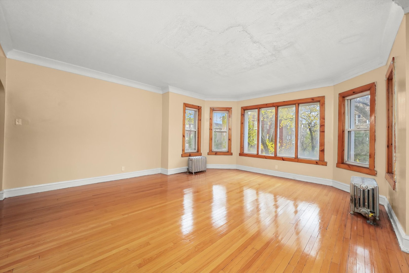 7825 South Phillips Avenue Chicago, IL 60649 - Photo 17 of 55 a view of an empty room with wooden floor and a window