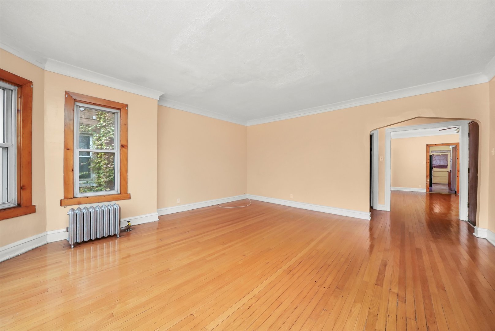 7825 South Phillips Avenue Chicago, IL 60649 - Photo 19 of 55 an empty room with wooden floor and windows