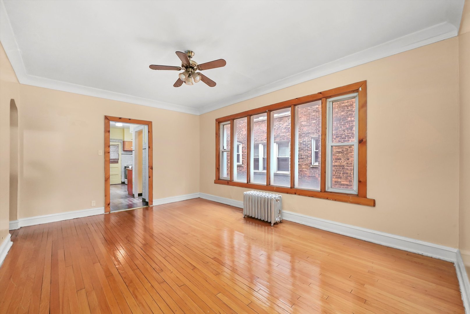 7825 South Phillips Avenue Chicago, IL 60649 - Photo 20 of 55 a view of an empty room with a window and wooden floor