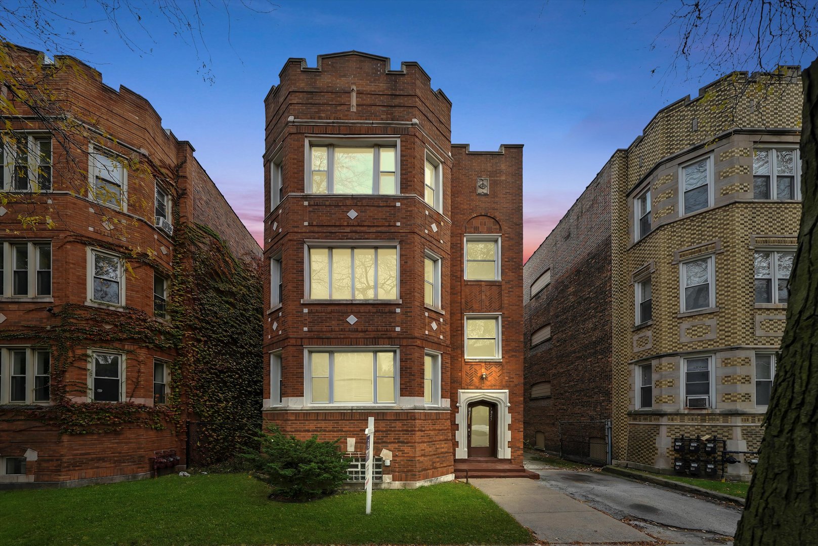7825 South Phillips Avenue Chicago, IL 60649 - Photo 2 of 55 a front view of a residential apartment building with a yard