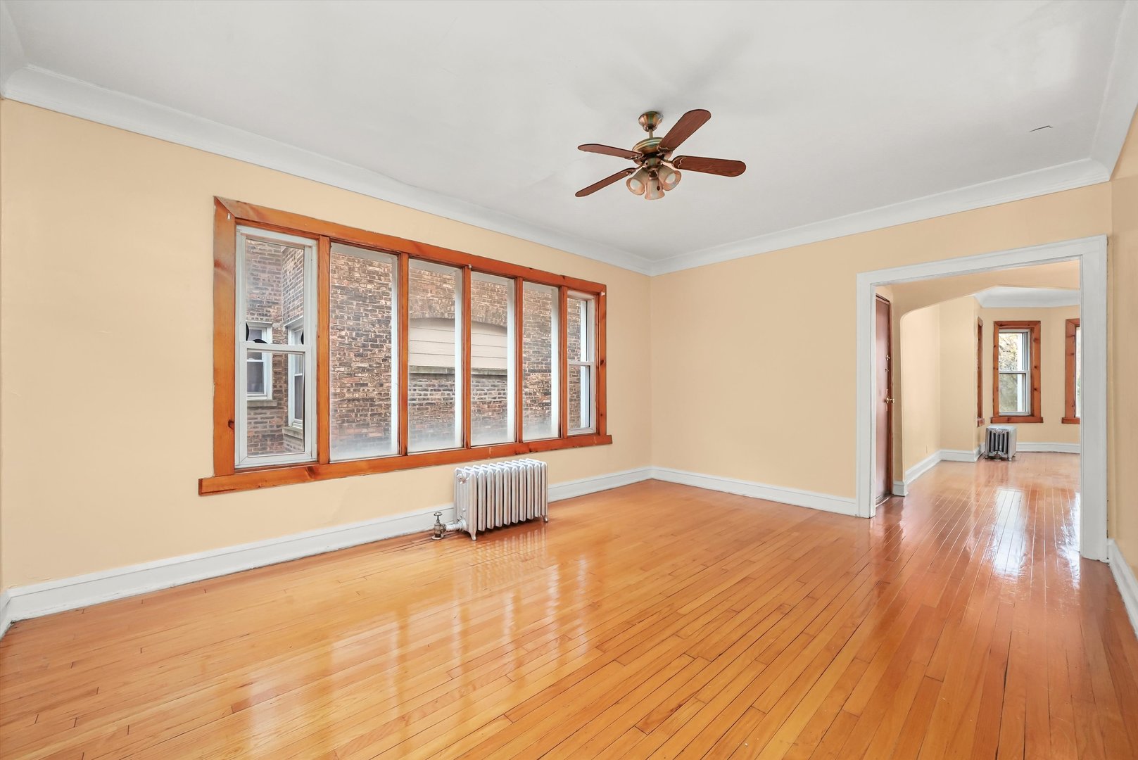 7825 South Phillips Avenue Chicago, IL 60649 - Photo 21 of 55 a view of an empty room with window and wooden floor