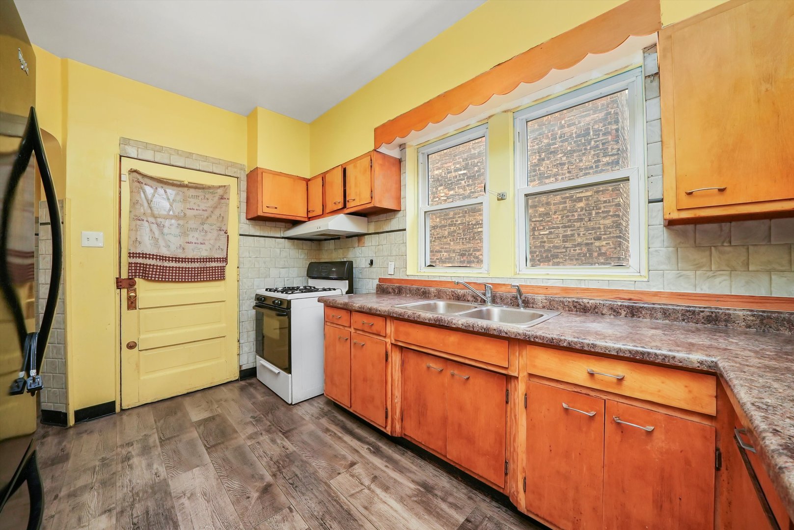 7825 South Phillips Avenue Chicago, IL 60649 - Photo 22 of 55 a kitchen with granite countertop a sink and a window