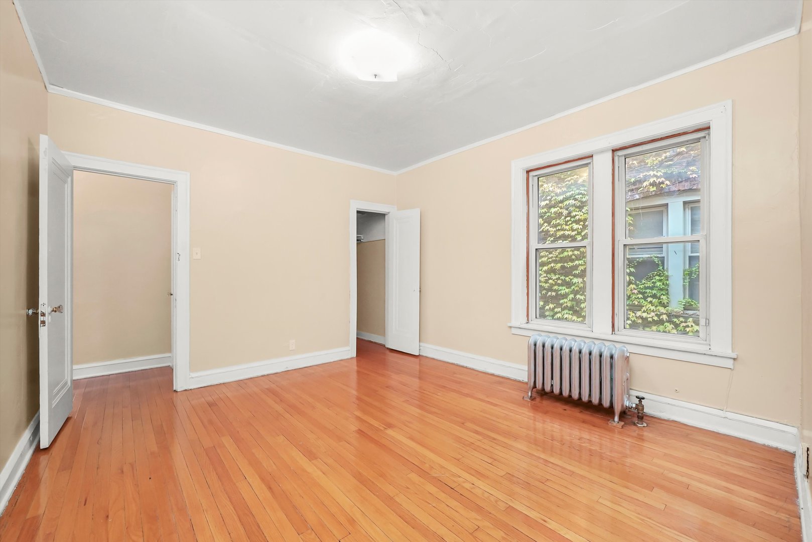 7825 South Phillips Avenue Chicago, IL 60649 - Photo 26 of 55 an empty room with wooden floor and windows