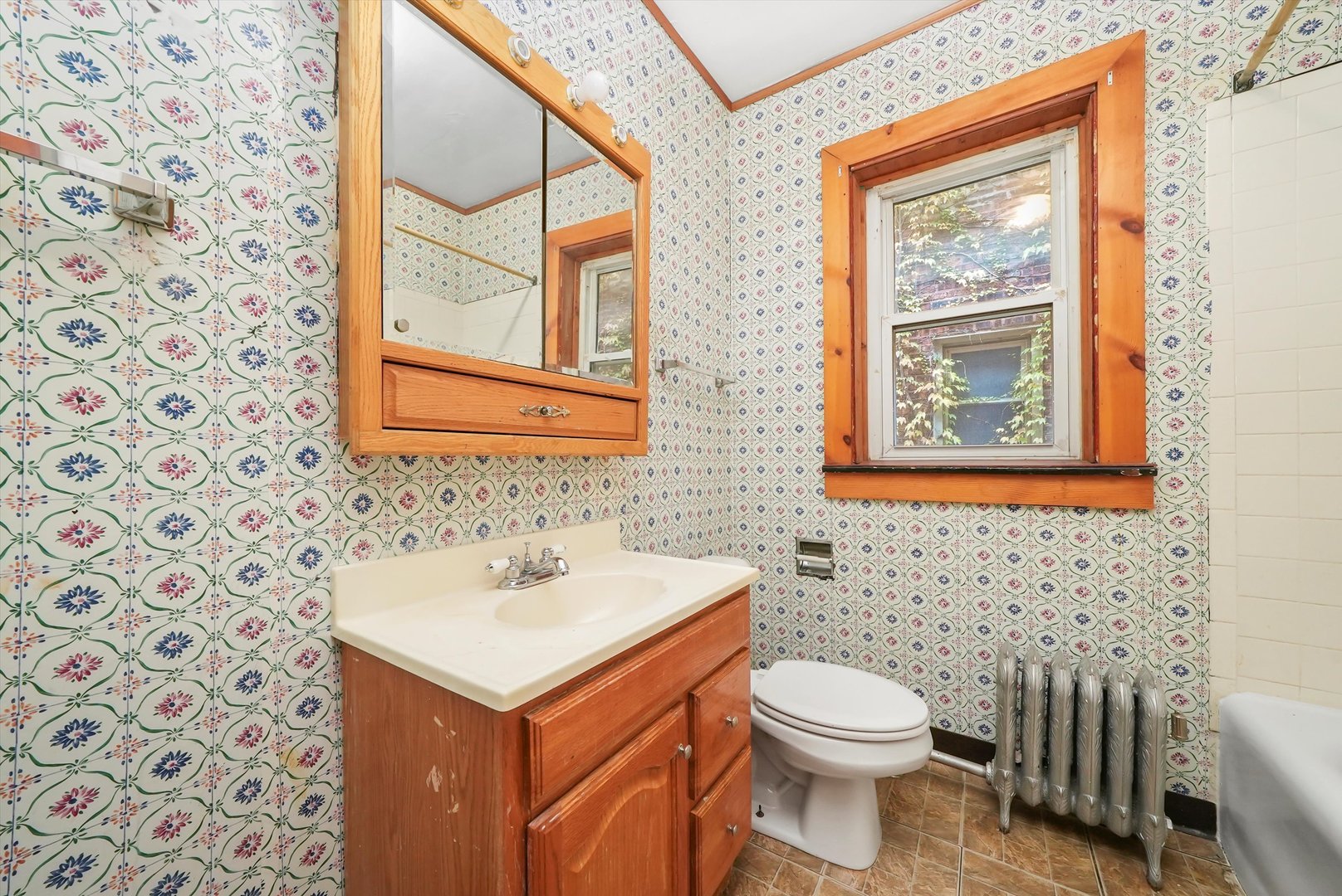 7825 South Phillips Avenue Chicago, IL 60649 - Photo 27 of 55 a bathroom with a sink a toilet and a mirror