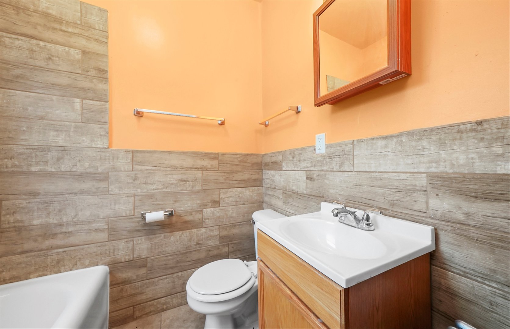 7825 South Phillips Avenue Chicago, IL 60649 - Photo 30 of 55 a bathroom with a sink a toilet and a mirror