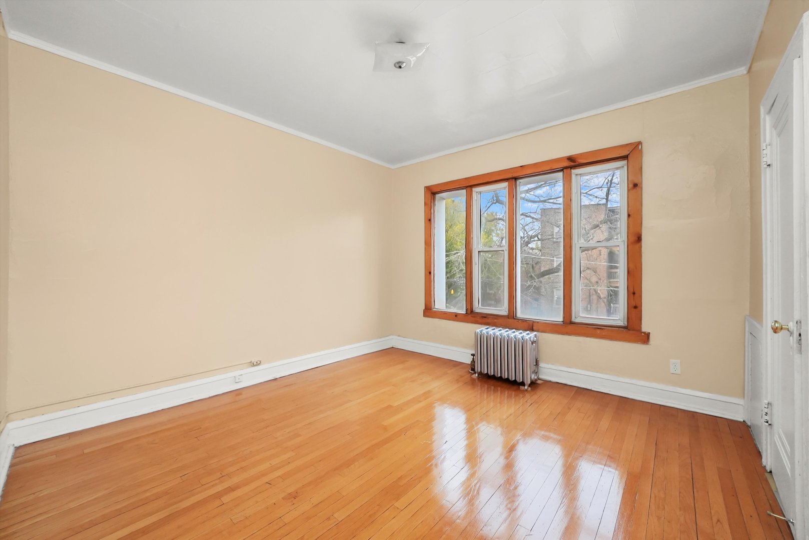 7825 South Phillips Avenue Chicago, IL 60649 - Photo 32 of 55 an empty room with wooden floor and windows