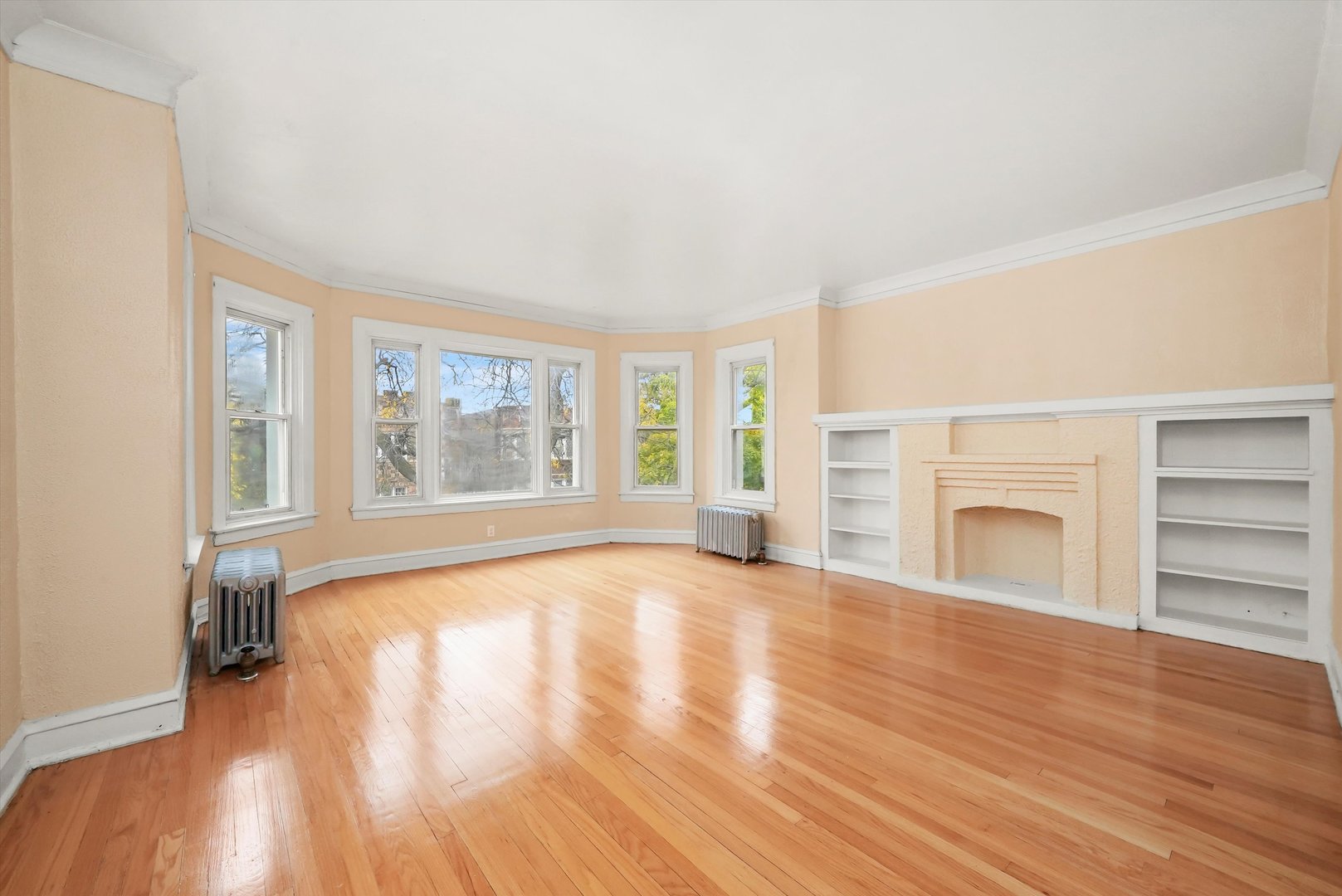 7825 South Phillips Avenue Chicago, IL 60649 - Photo 34 of 55 wooden floor fireplace and windows in an empty room