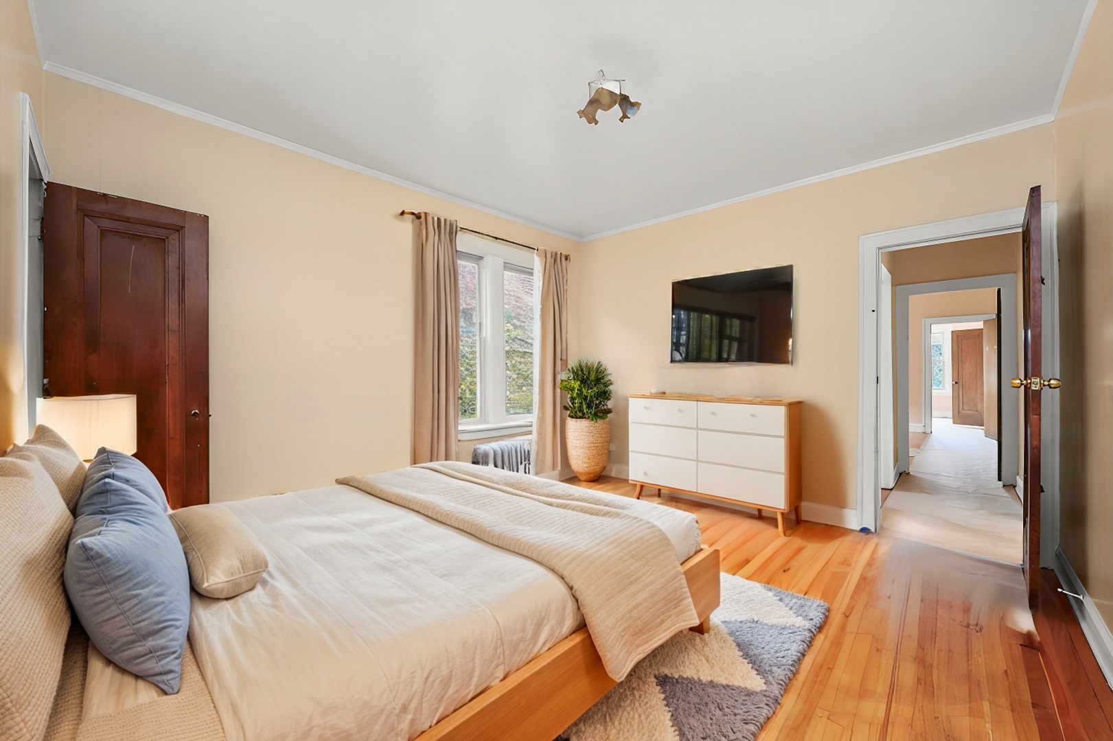 7825 South Phillips Avenue Chicago, IL 60649 - Photo 36 of 55 a bedroom with a bed and a flat screen tv