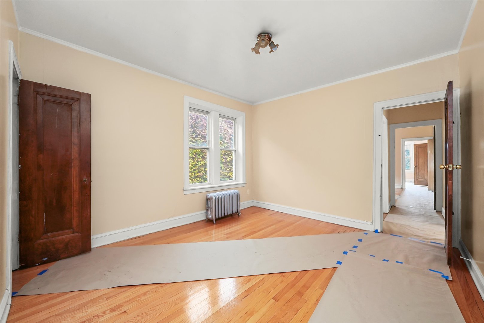 7825 South Phillips Avenue Chicago, IL 60649 - Photo 37 of 55 a view of an empty room with wooden floor and a window