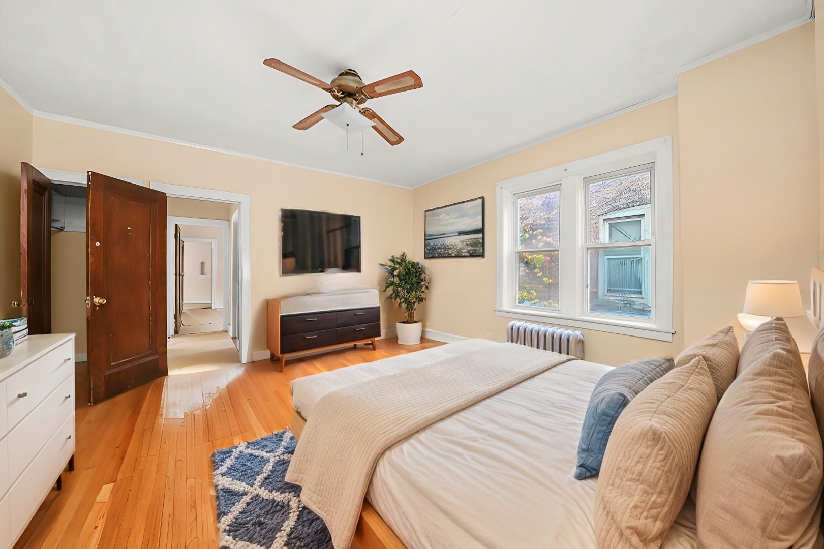 7825 South Phillips Avenue Chicago, IL 60649 - Photo 39 of 55 a bedroom with a bed and a flat screen tv