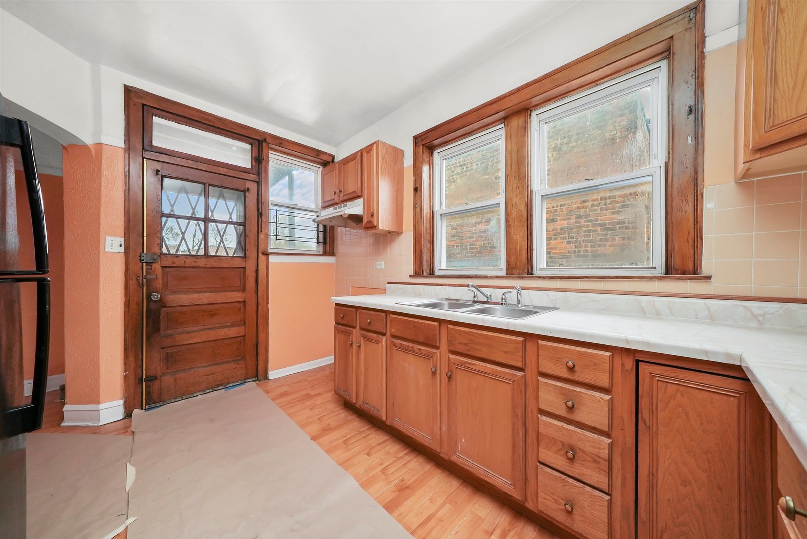 7825 South Phillips Avenue Chicago, IL 60649 - Photo 45 of 55 a kitchen with stainless steel appliances granite countertop a refrigerator and a sink