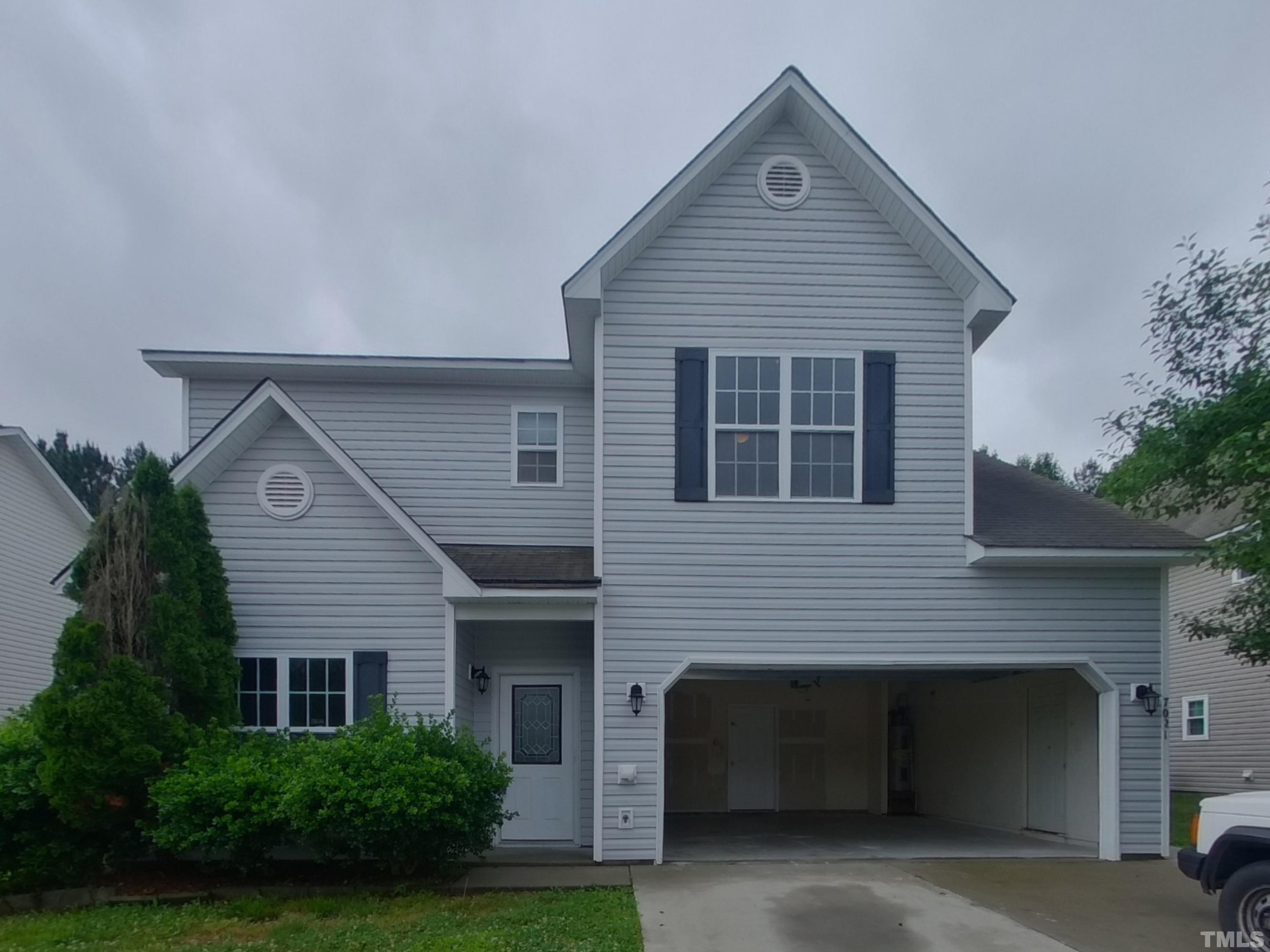 a front view of a house with garage