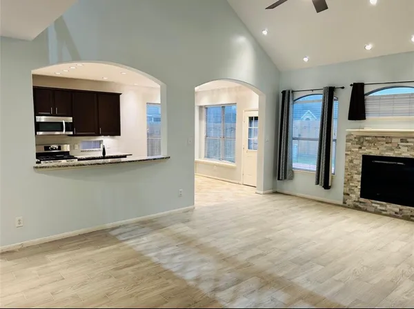 a view of kitchen with kitchen island microwave and refrigerator