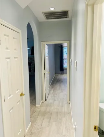 a view of a hallway with wooden shelves