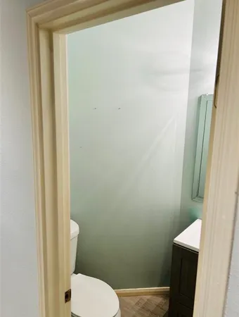 a white toilet sitting next to a shower