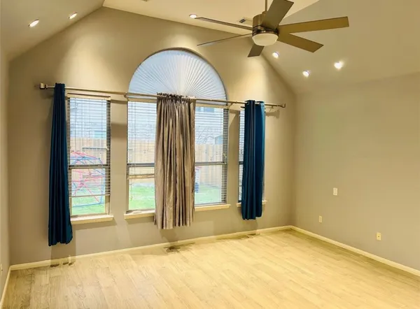 a view of an empty room with glass door