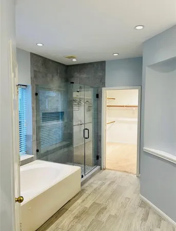 a bathroom with a bathtub and a shower