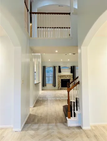 a view of entryway livingroom and hall with wooden floor