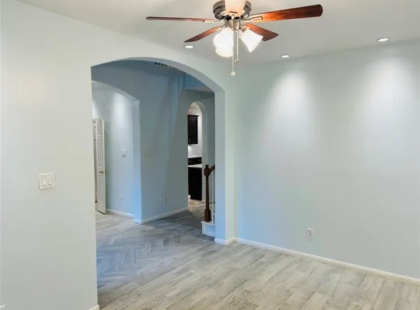 an empty room with closet and a chandelier fan