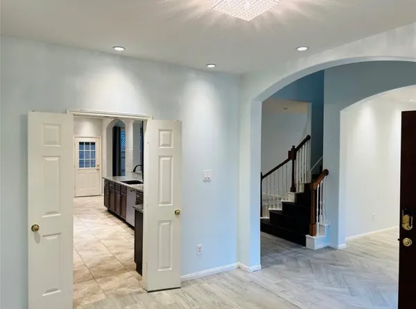 a view of a hallway with wooden floor and staircase