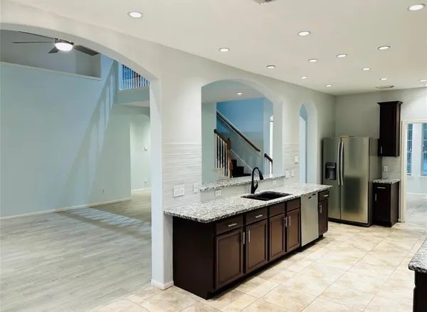 a kitchen with stainless steel appliances granite countertop a sink and a stove