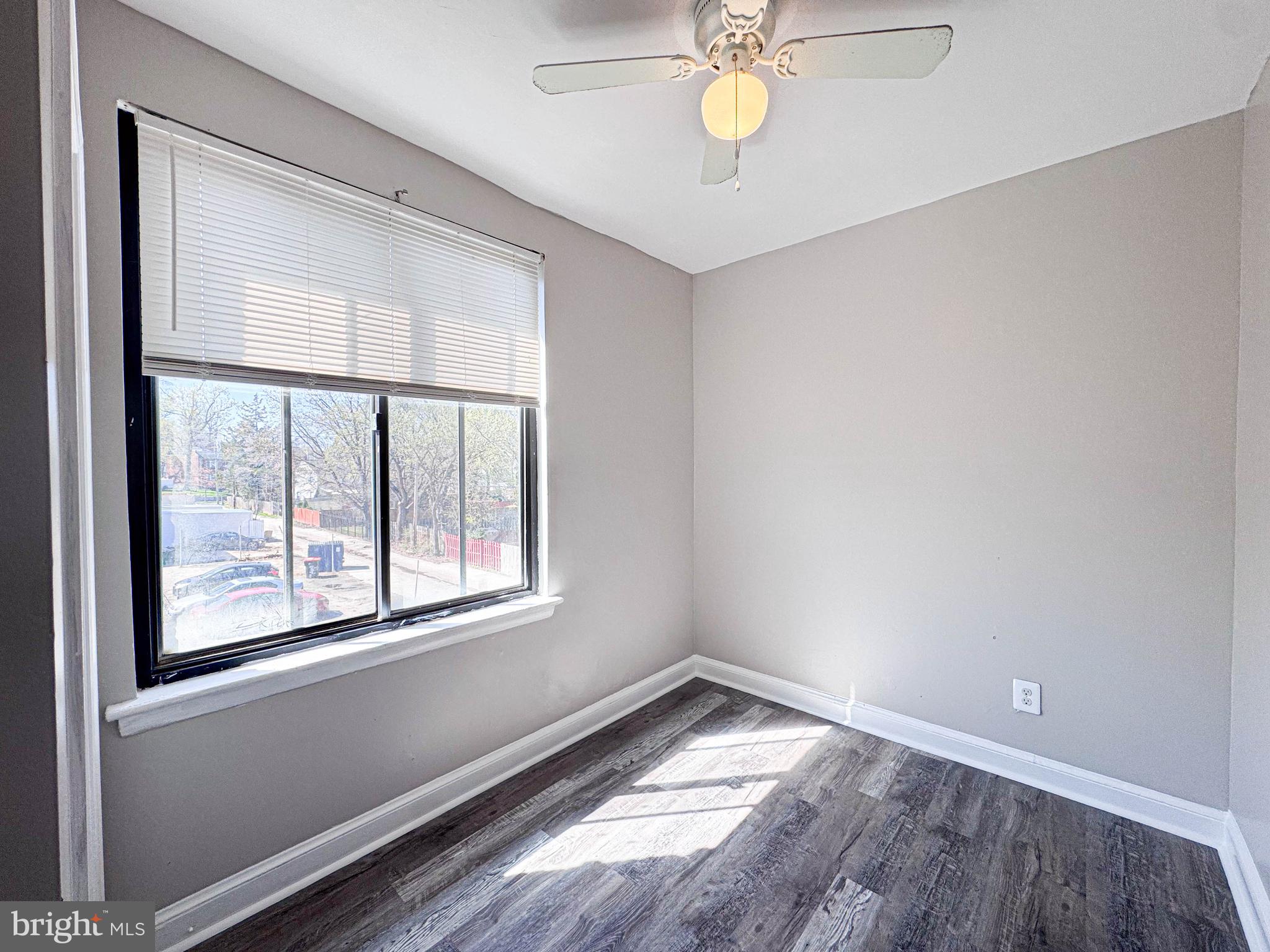 4630 Hillside Road Southeast, Unit 3 & 4 Washington, DC 20019 - Photo 14 of 23 an empty room with wooden floor and windows