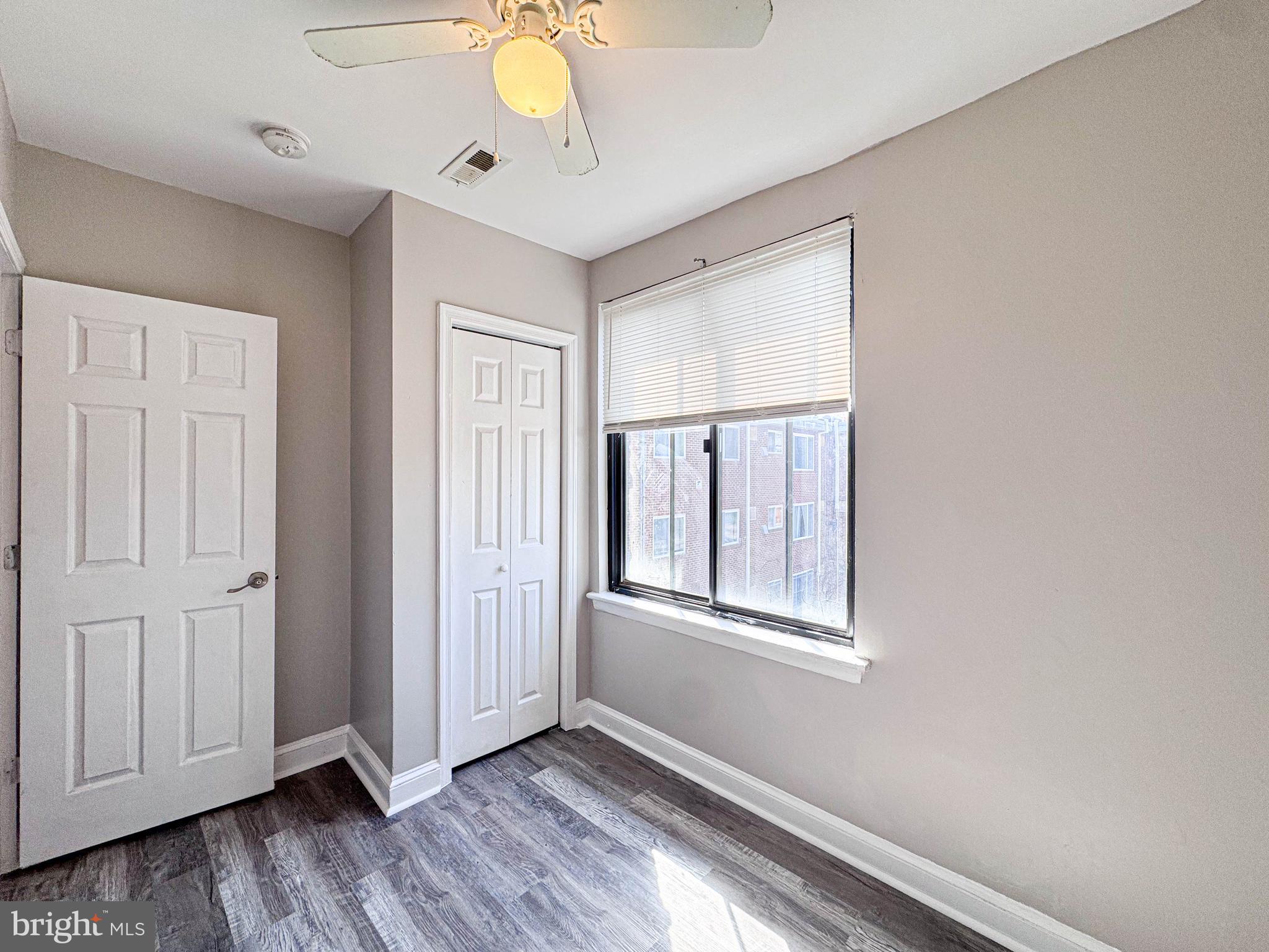 4630 Hillside Road Southeast, Unit 3 & 4 Washington, DC 20019 - Photo 17 of 23 a view of an empty room with wooden floor and a window