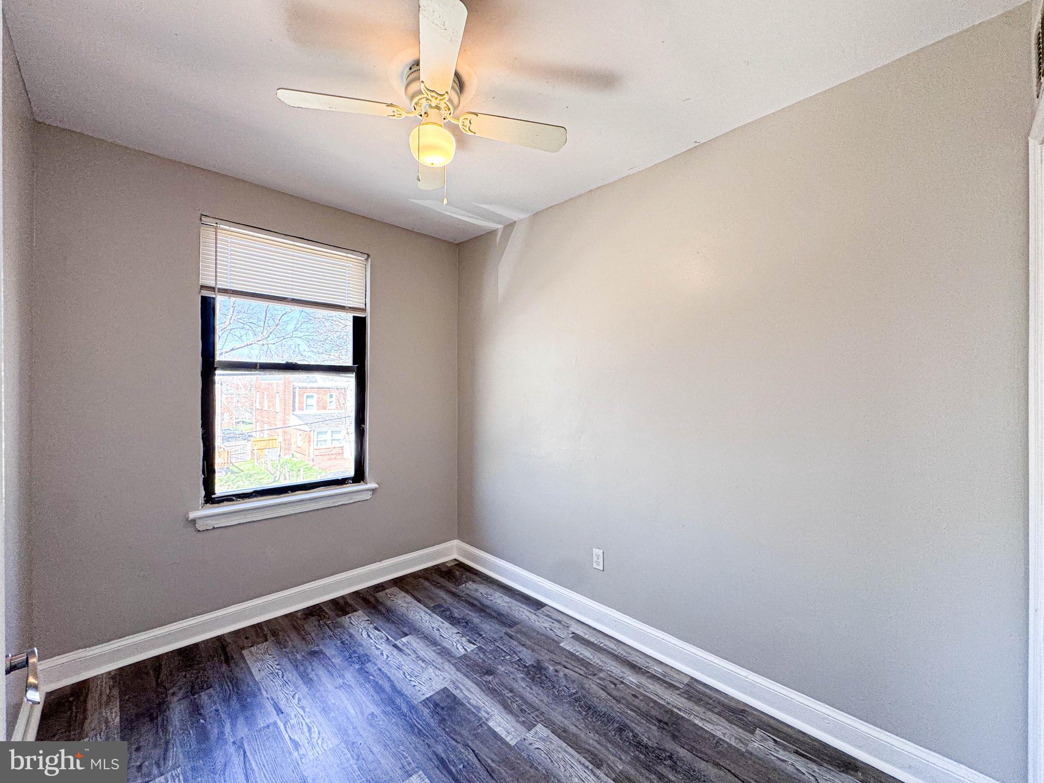 4630 Hillside Road Southeast, Unit 3 & 4 Washington, DC 20019 - Photo 18 of 23 an empty room with a window and wooden floor