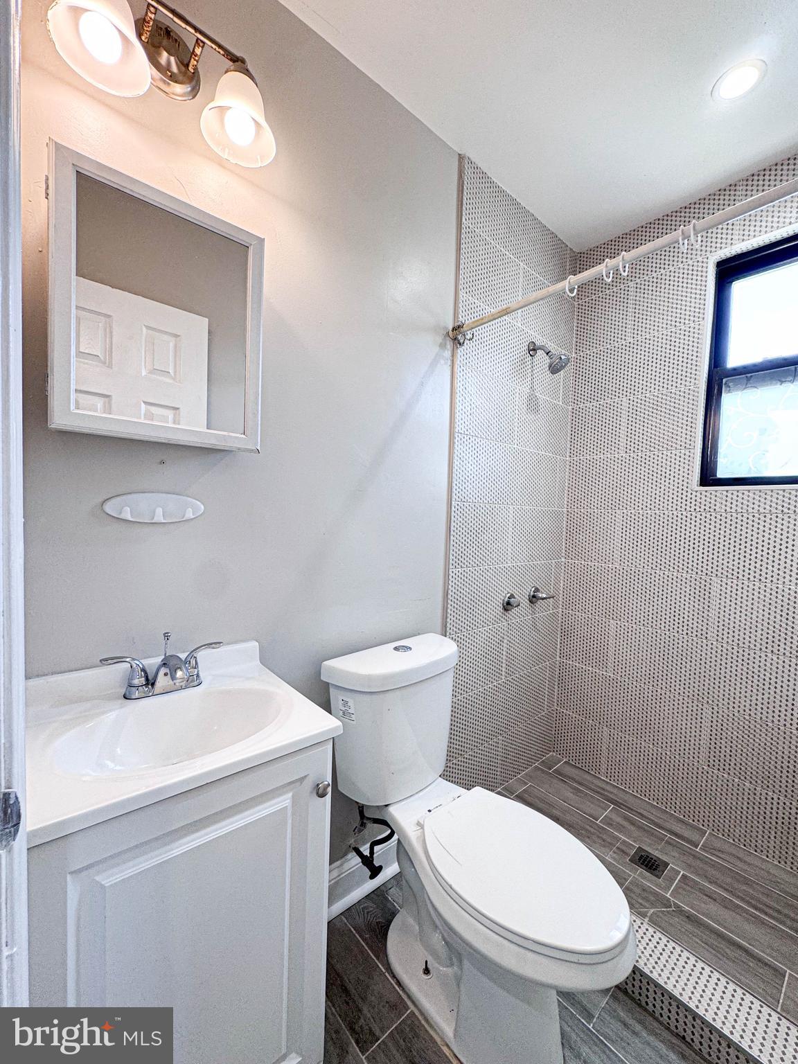 4630 Hillside Road Southeast, Unit 3 & 4 Washington, DC 20019 - Photo 2 of 23 a bathroom with a toilet a sink and mirror