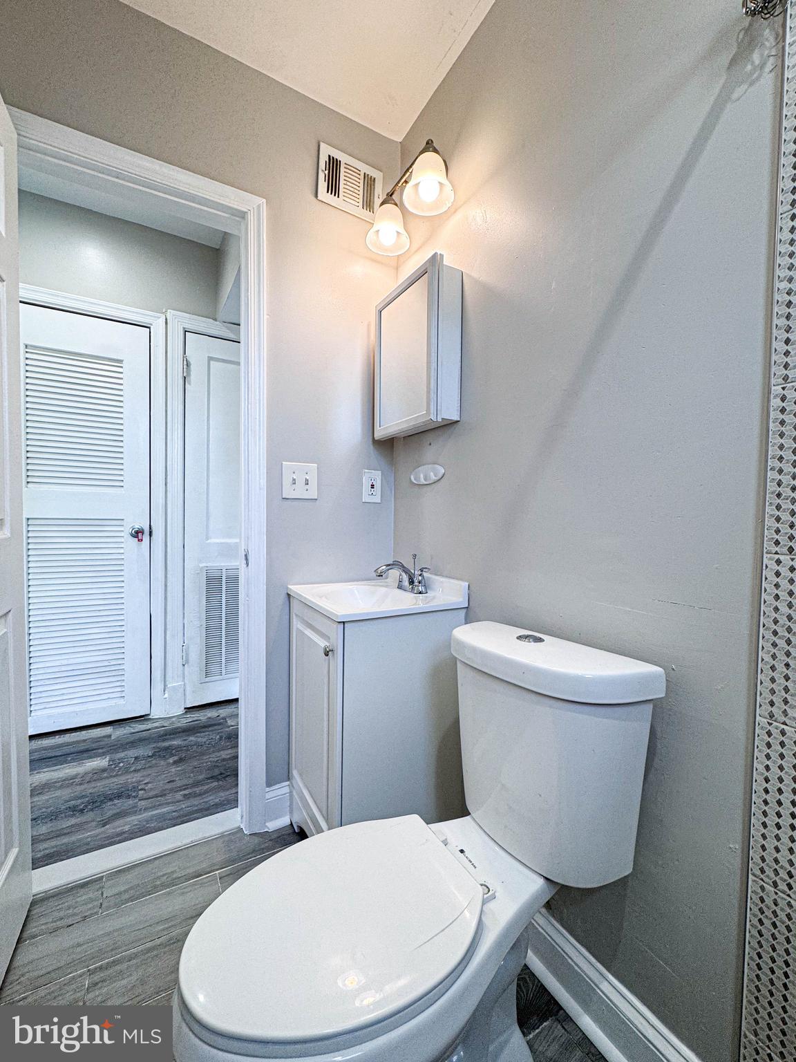 4630 Hillside Road Southeast, Unit 3 & 4 Washington, DC 20019 - Photo 3 of 23 a bathroom with a toilet a sink and mirror