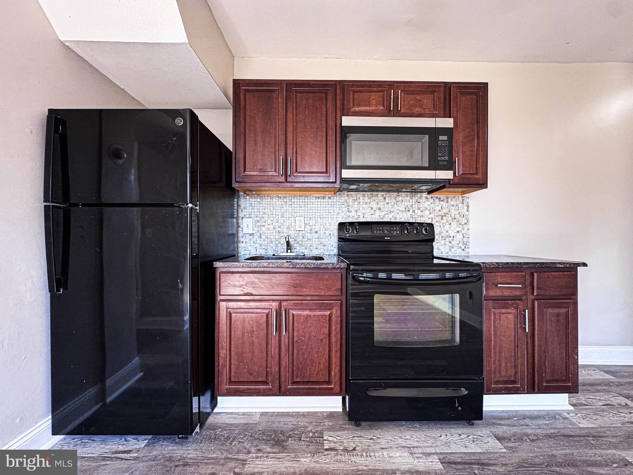 4630 Hillside Road Southeast, Unit 3 & 4 Washington, DC 20019 - Photo 9 of 23 a kitchen with stainless steel appliances granite countertop a stove and a refrigerator