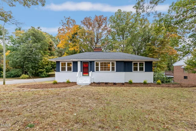 a front view of a house with a garden