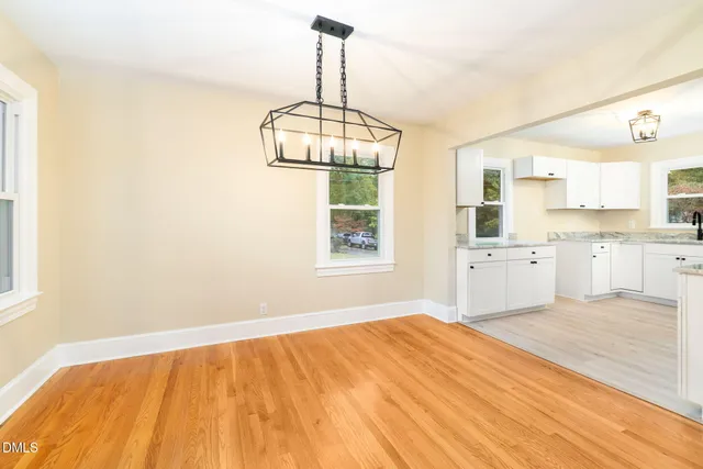 a kitchen with a sink cabinets appliances and a window