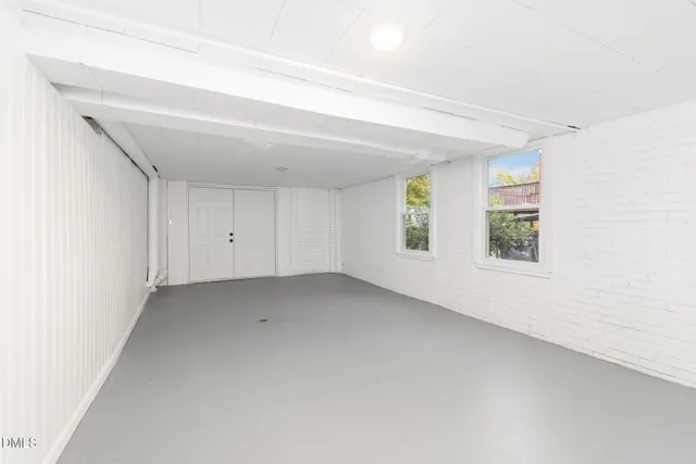 a view of an empty room with a fireplace