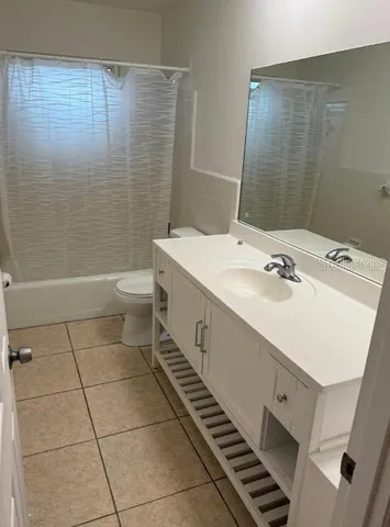 a bathroom with a sink toilet and mirror